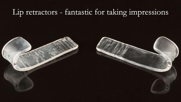 Lip retractors fashioned from photographic retractors are very useful for correct position of the impression tray in the mouth